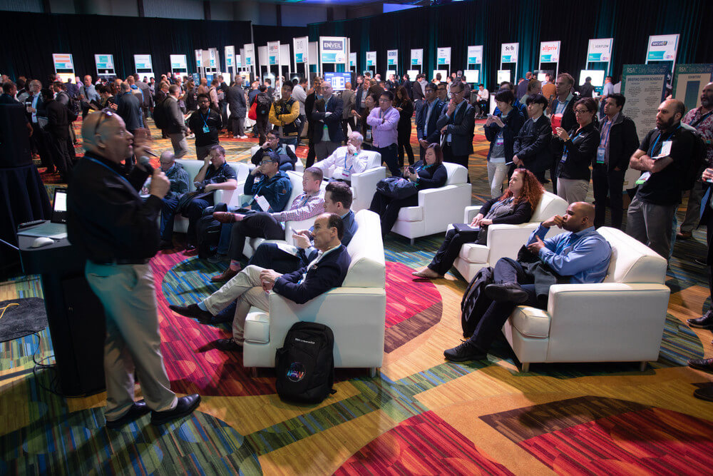 Seating area at the RSA conference with people watching a presentation.